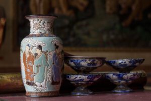 Intricate ceramic vase and bowls